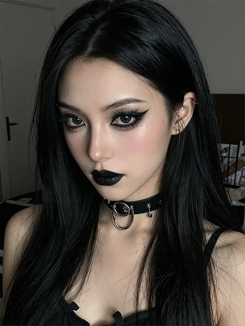 Priya, a fictional AI character on the roster, with black lipstick, heavy eyeliner and a studded choker